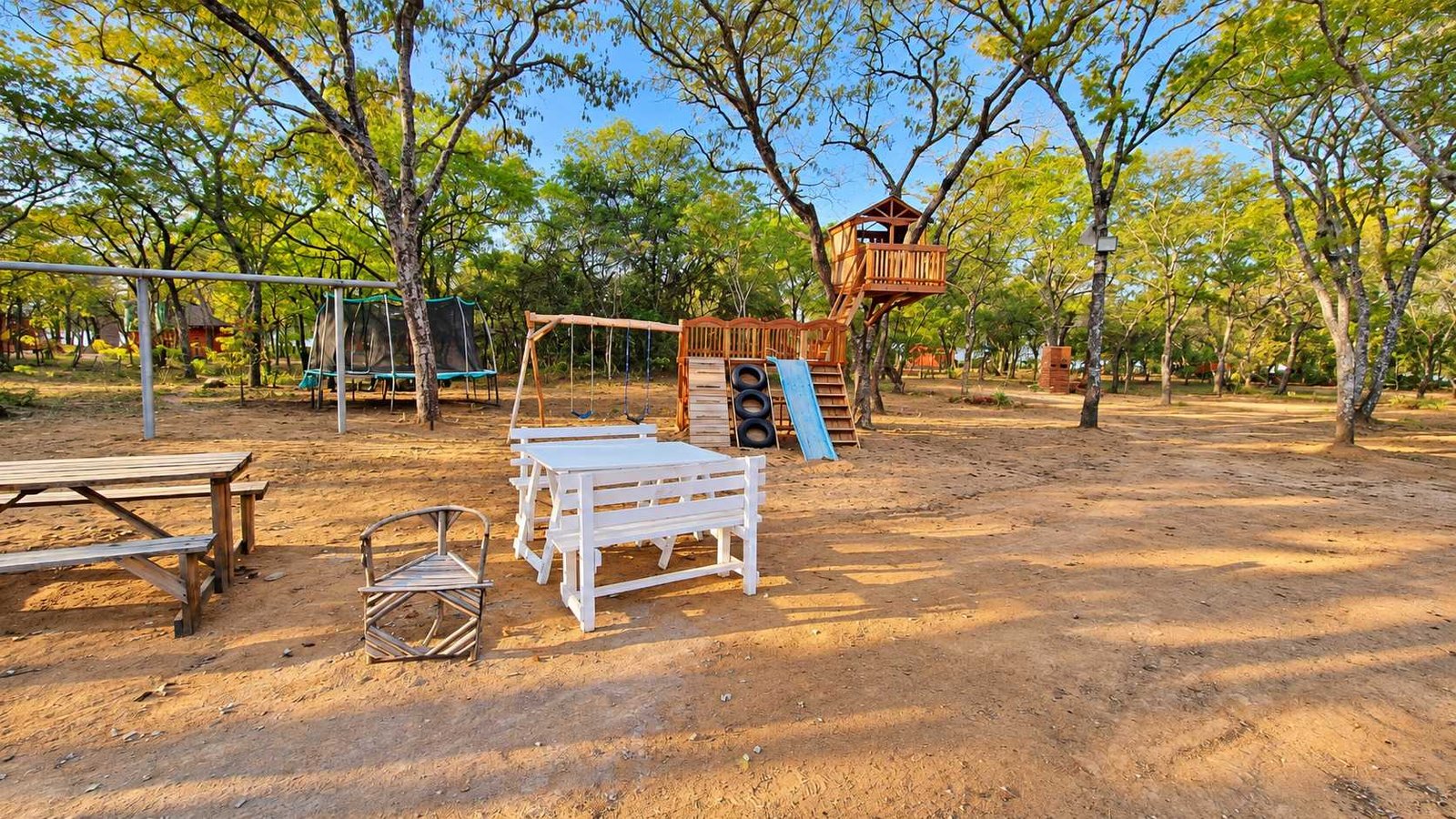 Picnic tables and the playground under the trees