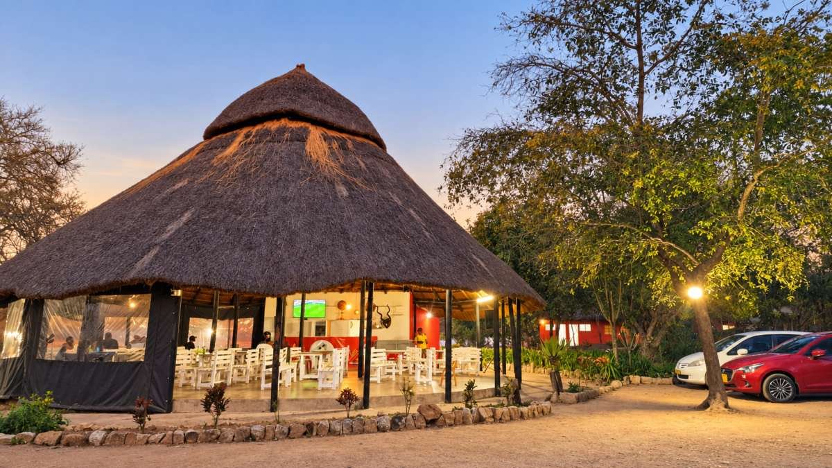 Mafuramhepo Grills, the thatched restaurant, lit at dusk