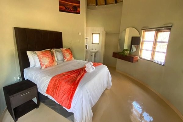 Chalet bedroom with a king-size bed and orange throw