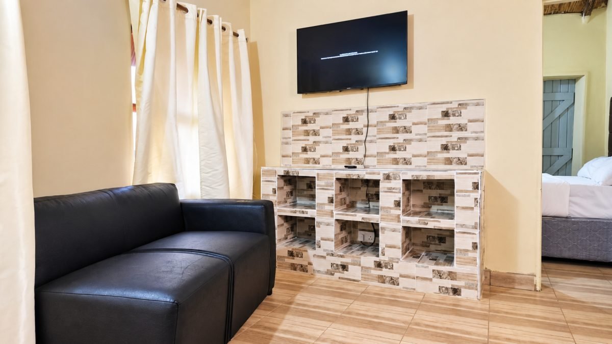 Family Chalet lounge with a black sofa and wall-mounted TV